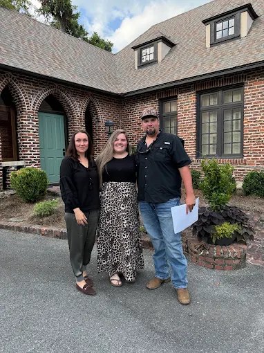 Three of our buyers outside a home