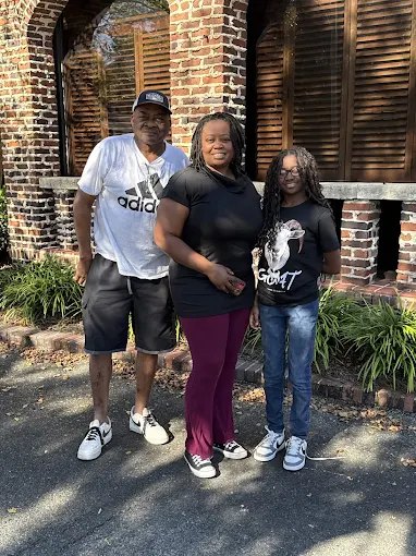 A family of three of our buyers outside a home