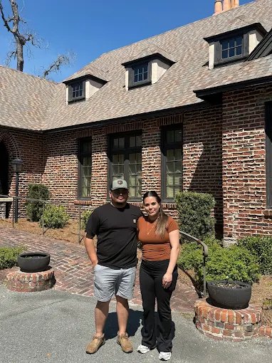 Two of our buyers outside a home