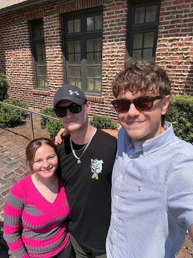 Three young buyers outside a home